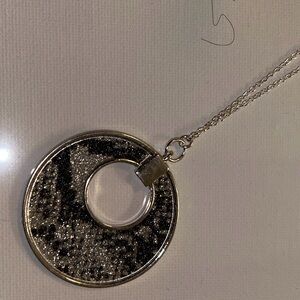 Beautiful long silver necklace featuring a round pendant